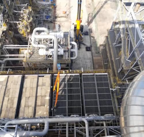A custom-fabricated rigging solution being used to lift a large industrial component.