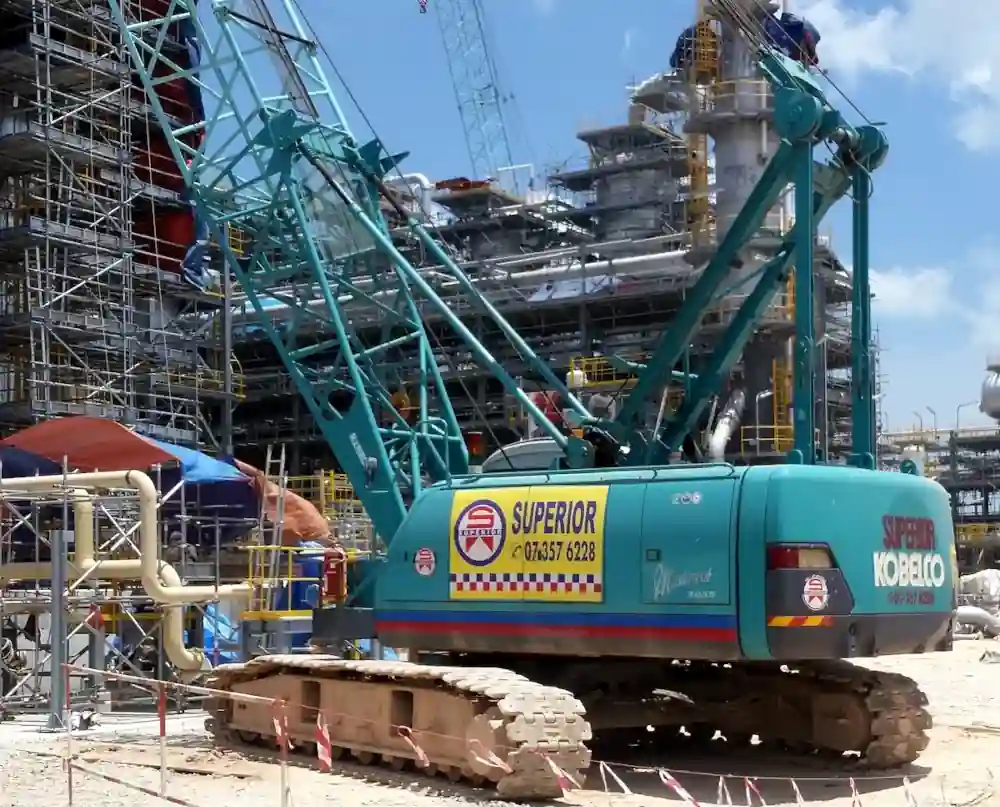A 55-ton crawler crane operating at a Petronas oil and gas plant.
