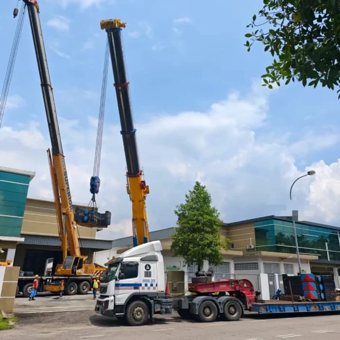 A multi-axle low loader transporting an excavator.