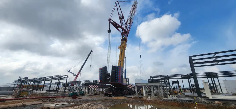 Side view of the heavy lift crane on the data center construction site.