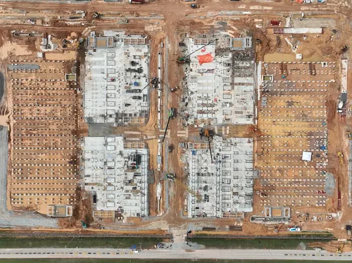 Drone photo showing Superior Machinery mobile cranes at a data center construction site in Johor Bahru.
