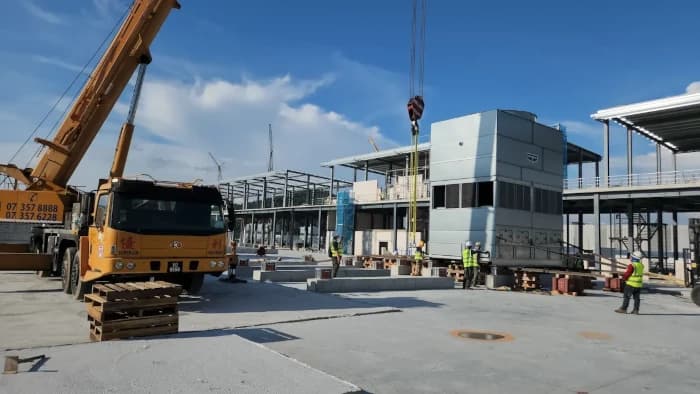 A truck crane assisting with machinery moving solutions for a data center cooling tower.