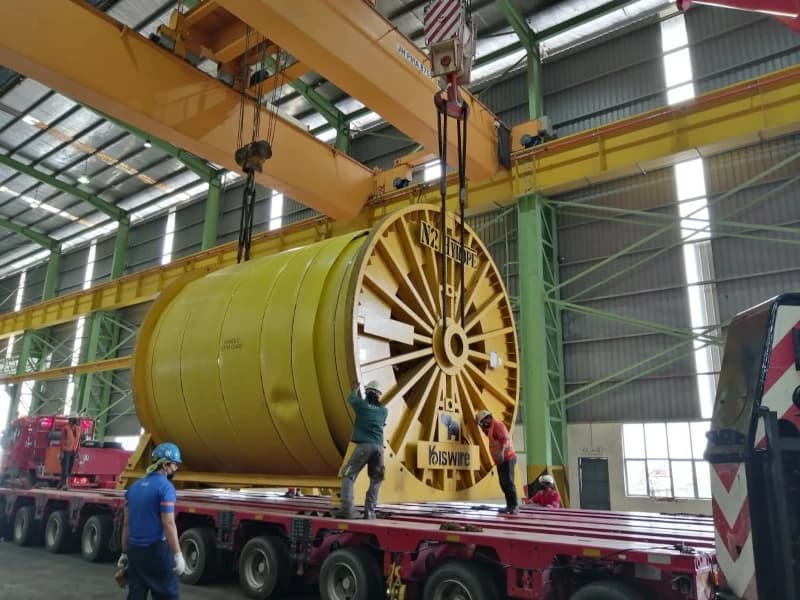 A multi-axle trailer rental from Superior Machinery transporting a large industrial reel for Kiswire in Johor.